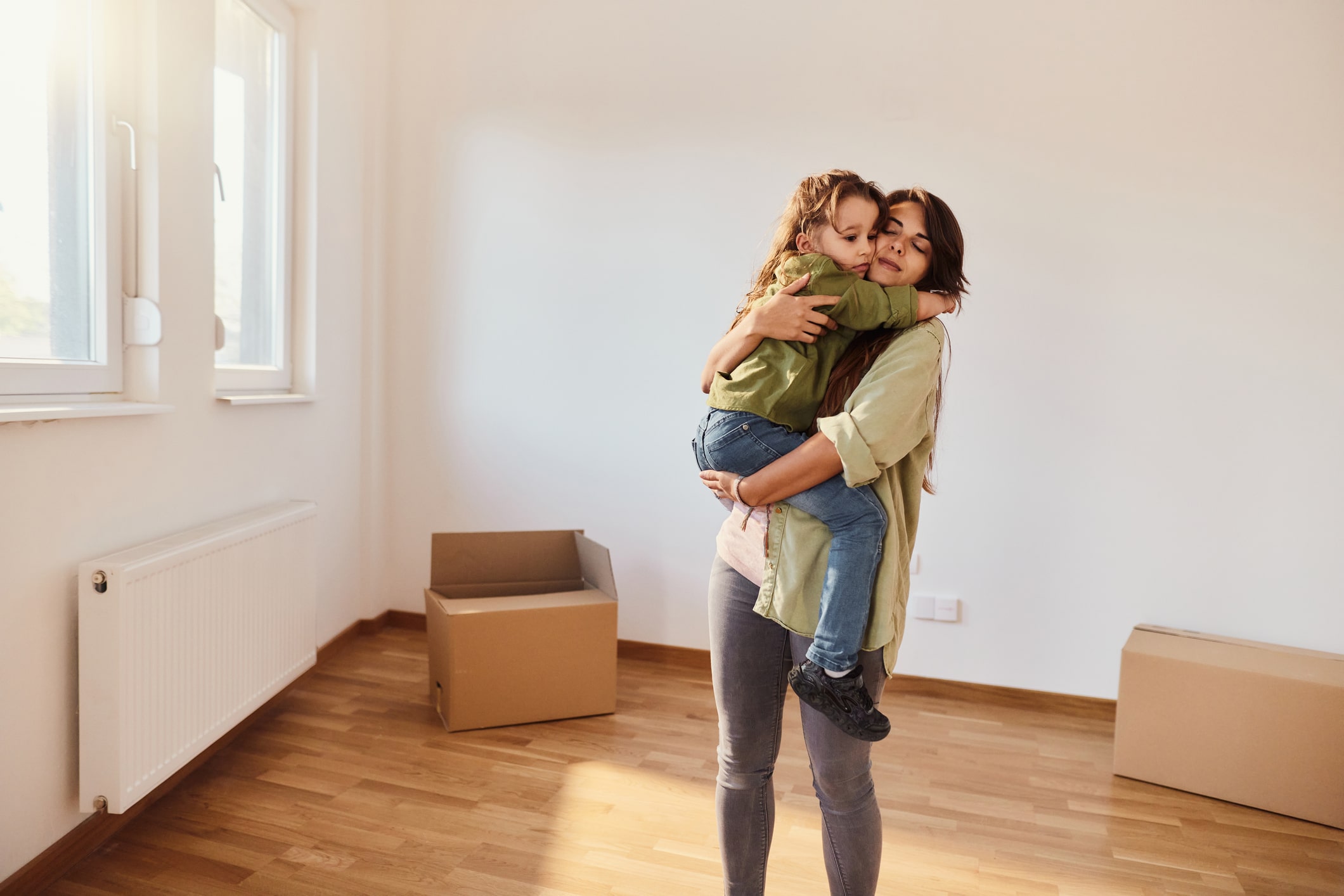 Loving single mother and daughter in their new apartment.